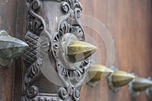 Ancient traditional wooden carved door with ornaments and bronze spike in Stone Town on island Zanzibar, Tanzania, East Africa