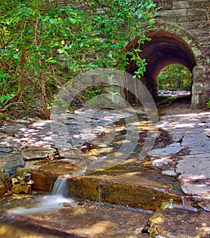 Ancient tunnel with stream