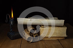 Ancient Unfolded and Rolled Scrolls, Ancient Books and a burning candle