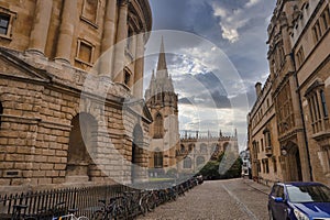 Historic buildings and parked bicycles with St. Mary's church in Oxford, England