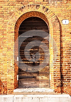 Ancient Venetian wooden door at night.