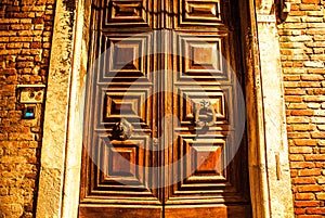 Ancient Venetian wooden door at night.