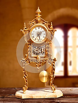 Ancient vintage golden brass pendulum clock