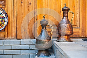 ancient vintage oriental Uzbek copper jugs with East Asian ornaments in Uzbekistan