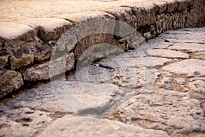 Ancient walking path stones texture. Ruins of ancient roman town Ercolano - Herculaneum