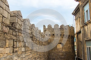 Ancient wall of old Baku. Old walls and new buildings together in Icheri sheher