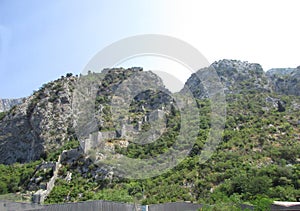 Ancient Wall rises on the mountain to the Fortress St Jons over Kotor in Montenegro