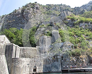 Ancient Wall rises on the mountain to the Fortress St Jons over Kotor in Montenegro