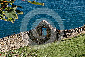 Ancient wall with a window to the sea