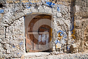 Ancient walls and and entrance wooden door at Rhodes old town, Greece