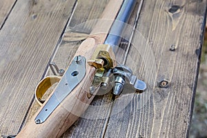 Ancient weapons with an iron barrel and a wooden butt on an old table