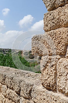 Ancient weathered stone wall in archeological park in Israel photo
