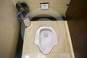 Ancient white squat toilet latrine in Changsha airport, China