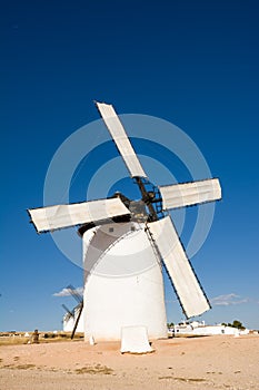 Ancient windmill in Campo de Criptana (Spain) with the blades covered by a cloth ready to go into operation