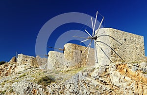 Ancient windmills against a bright blue sky of Lasithi Plateau on Crete, Greece