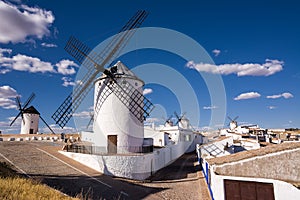 Ancient windmills near houses in Campo de Criptana, Spain,