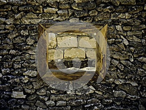 Ancient window in a stone wall with wine on the brick wall of hopelessness