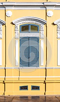 Ancient window with yellow background photo