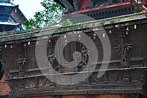 Ancient wood architecture and antique art wooden carved nepalese angel deity god in old ruins building for nepali people foreign