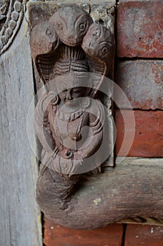 Ancient wood architecture and antique art wooden carved nepalese angel deity god in old ruins building for nepali people foreign