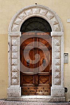 Ancient wood door of a historic building in Perugia (Tuscany, Italy)