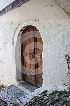 Ancient wood door on a tight alley of Berat