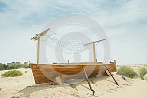 Ancient wooden boat on the sand in the desert