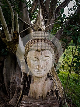 Ancient wooden Buddha statue head cracked