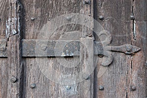 Ancient Wooden Door with Fleur-de-lis Ironwork photo