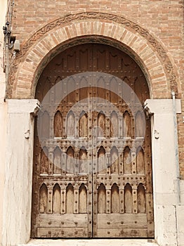 Ancient wooden door from Italy. Medieval stone wall