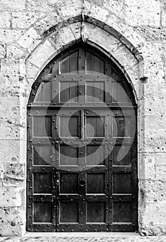 Ancient wooden door leading into Palais des Archeveques at Narbonne in france