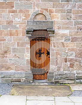 Ancient wooden door set on blocks of stone