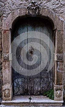 ancient wooden door of stone building