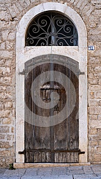 ancient wooden door of stone building