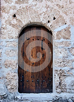 Ancient wooden door in a stone wall