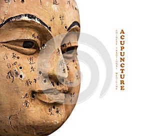 Ancient wooden face showing acupuncture points