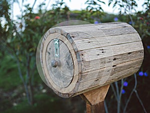 Ancient wooden handmade mailbox with clover leaves for happiness. Vintage brown wood postbox