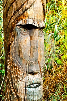 Ancient wooden idol of the Slavic god carved on a wooden pillar. The concept of religious pagan rites.