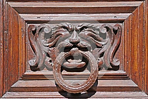 Ancient wooden and metallic door knocker