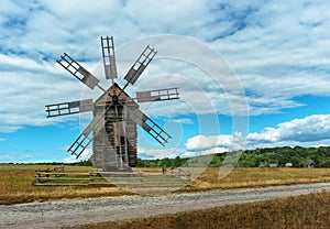 Ancient wooden mill in autumn field. Ukraine, Kiev, Porogovo