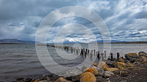 Ancient Wooden Pier at Puerto Natales with Birds and Mountains