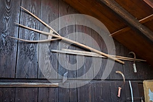 Ancient wooden pitchfork and sickles on old barn photo
