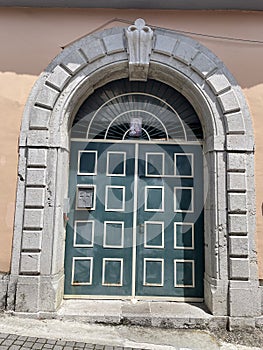 Ancient wooden portal with a stone arch