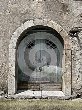 Ancient wooden portal with a stone arch