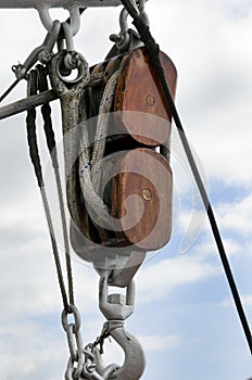 Ancient wooden sailboat pulley and ropes