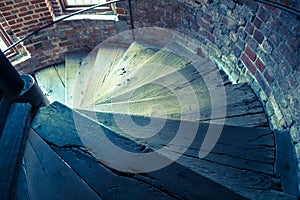 Ancient wooden spiral staircase in a old tower