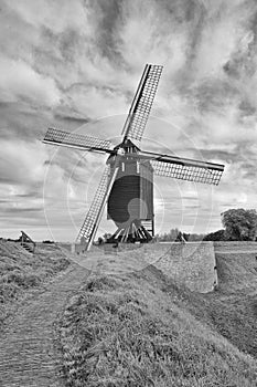 Ancient wooden windmill on a with dramatic shaped clouds, Heusden, The Netherlands