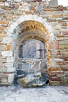 Ancient wooden window of medieval brick wall