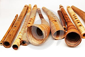 Ancient woodwind folk instruments on a white