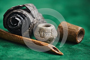 Ancient writing. Birch bark manuscript, bone stylos, clay spindle whorl, ancient bone product